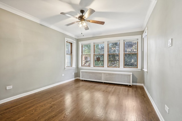 unfurnished room featuring radiator heating unit, hardwood / wood-style flooring, ceiling fan, and crown molding