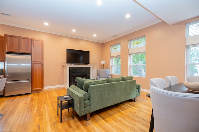 living room featuring light hardwood / wood-style floors and crown molding