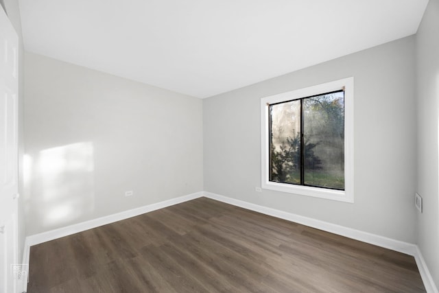 unfurnished room featuring dark wood-type flooring