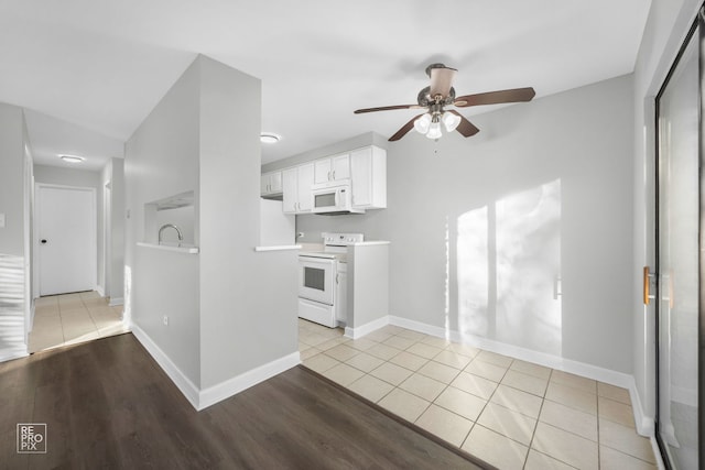 kitchen with white cabinets, light wood-type flooring, white appliances, and ceiling fan