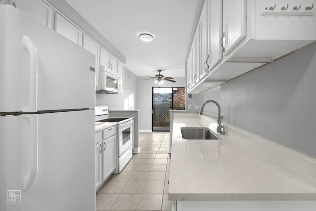 kitchen with white cabinetry, sink, ceiling fan, white appliances, and light tile patterned floors