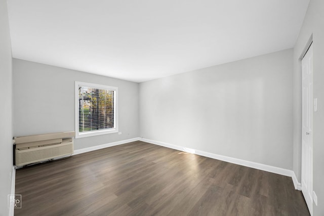 unfurnished room featuring dark hardwood / wood-style floors