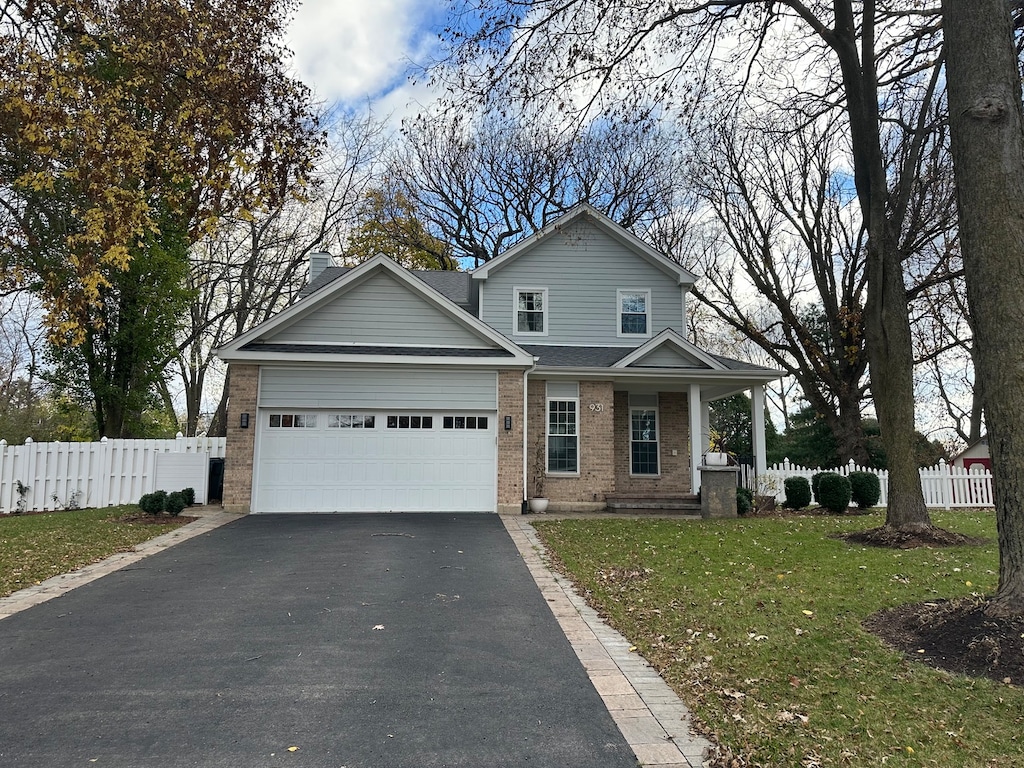 view of front of house with a front lawn, a porch, and a garage