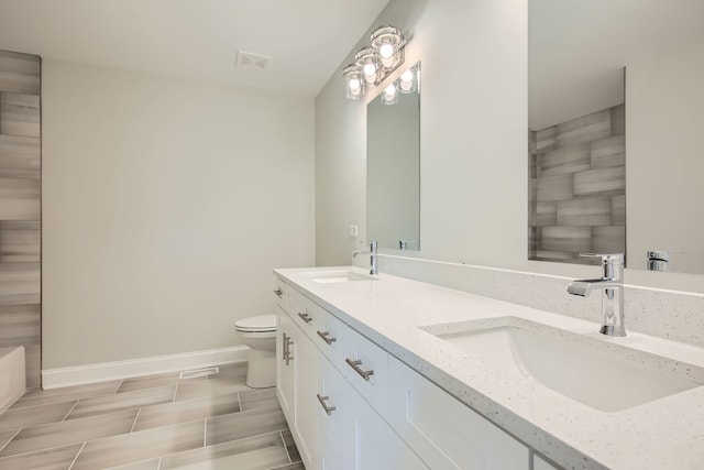 bathroom with vanity and toilet