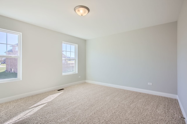 carpeted empty room with a wealth of natural light