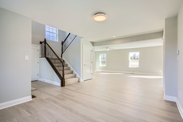 interior space with ceiling fan and light hardwood / wood-style flooring