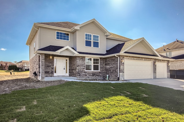 view of front of house with a garage and a front lawn