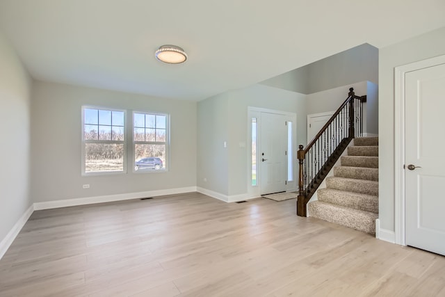 foyer entrance with light hardwood / wood-style floors