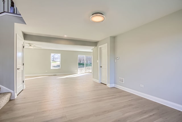 empty room featuring ceiling fan and light hardwood / wood-style flooring