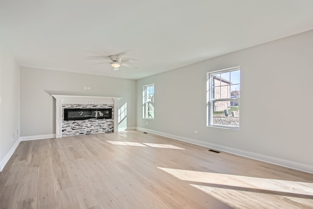 unfurnished living room featuring ceiling fan and light hardwood / wood-style flooring