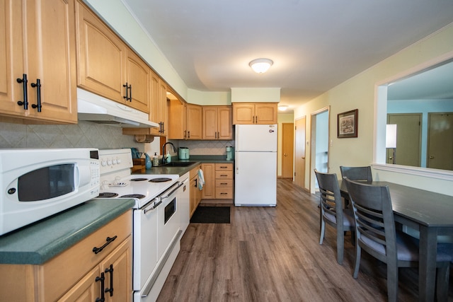 kitchen with white appliances, sink, backsplash, and dark hardwood / wood-style flooring