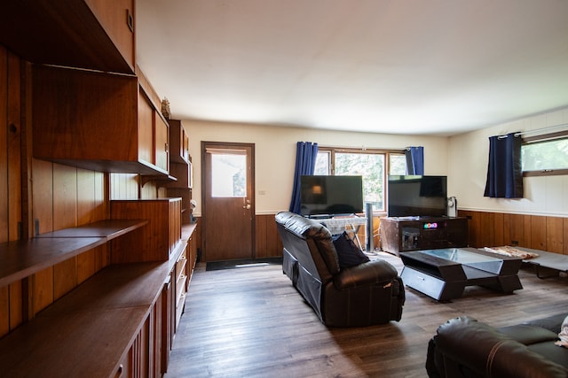 living room featuring hardwood / wood-style flooring and wood walls