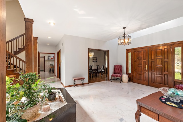 foyer entrance with a notable chandelier