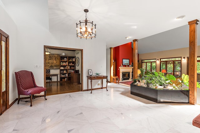 interior space with an inviting chandelier, high vaulted ceiling, and decorative columns