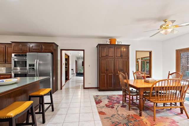 tiled dining room with ceiling fan