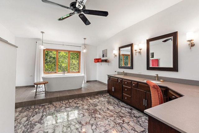 bathroom featuring ceiling fan, vanity, and a bath