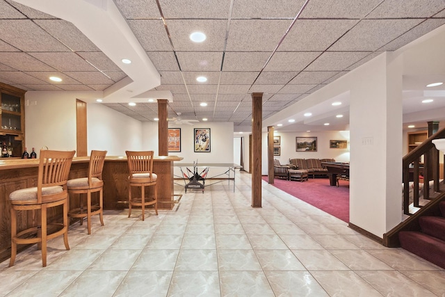 bar with billiards, light tile patterned floors, decorative columns, and a drop ceiling