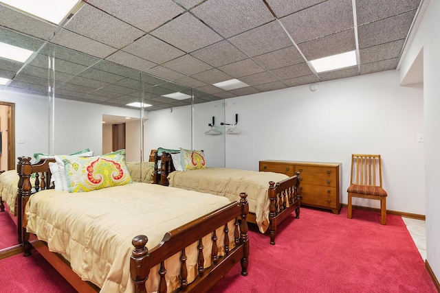 carpeted bedroom with a paneled ceiling