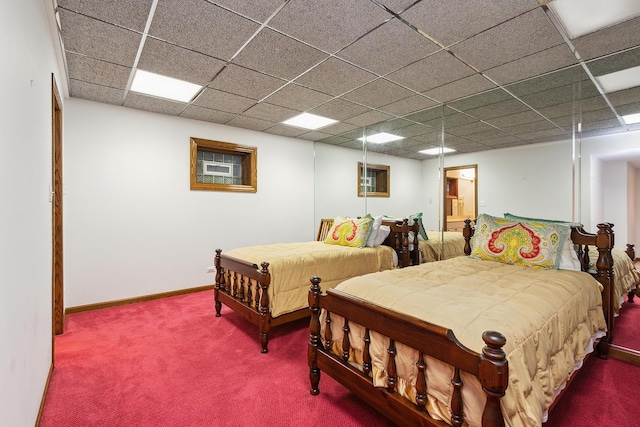 bedroom featuring carpet and a paneled ceiling