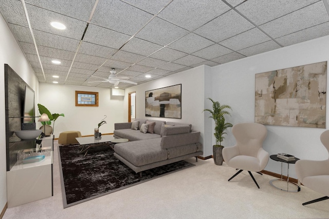 carpeted living room with a drop ceiling