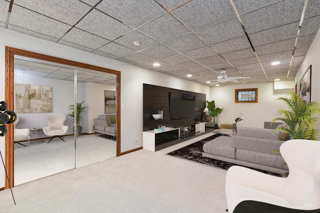 living room with carpet floors and a paneled ceiling