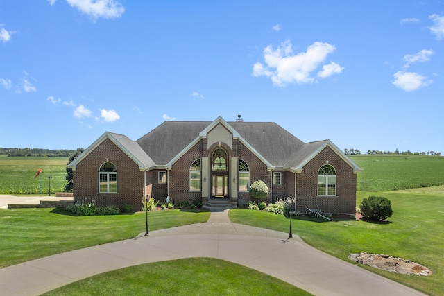 view of front of house featuring a rural view and a front yard