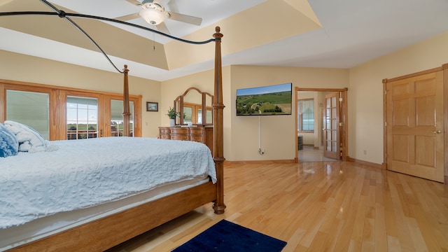 bedroom with ceiling fan, french doors, and light wood-type flooring