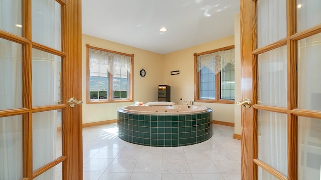 room details featuring tiled tub, tile patterned floors, and a hot tub