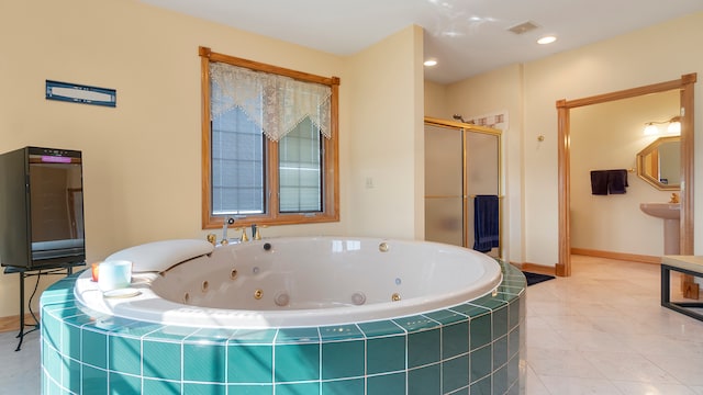 bathroom with separate shower and tub and tile patterned flooring