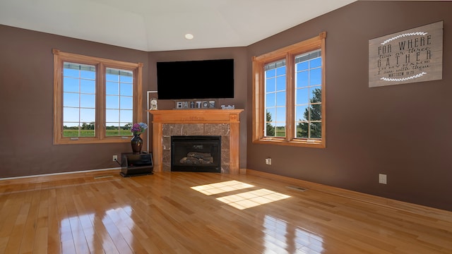 unfurnished living room with a fireplace and light hardwood / wood-style floors