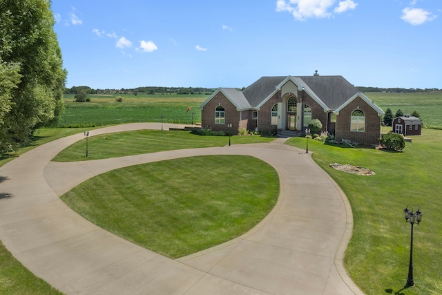 view of home's community featuring a rural view and a lawn