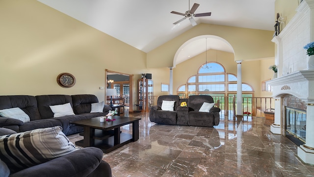 living room featuring decorative columns, a high end fireplace, high vaulted ceiling, and ceiling fan