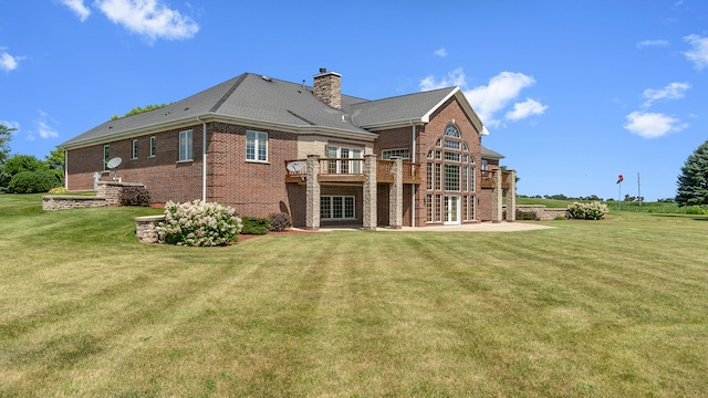 back of house featuring a lawn and a deck