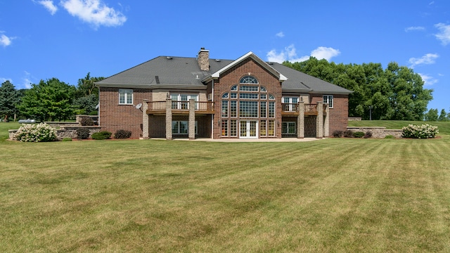 back of property featuring a lawn, a patio area, french doors, and a deck