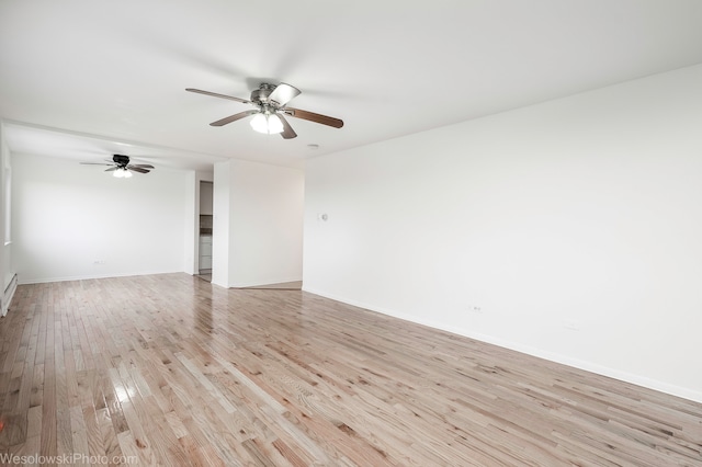 empty room featuring ceiling fan and light wood-type flooring