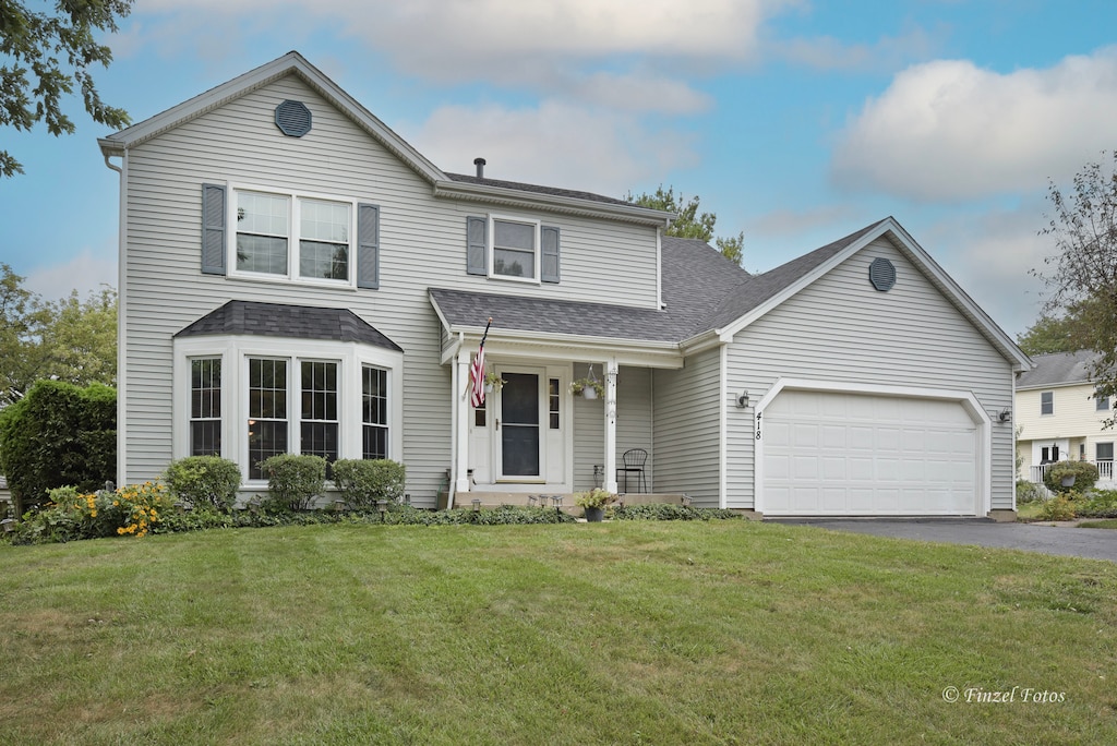 front facade featuring a front yard and a garage