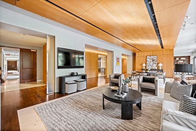 living room featuring hardwood / wood-style floors and wood ceiling