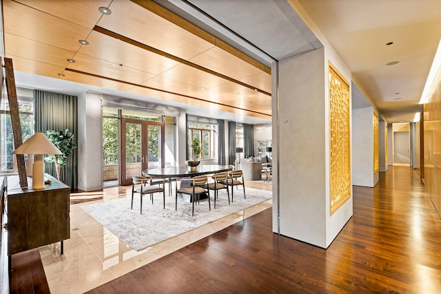 dining space featuring wood-type flooring and french doors