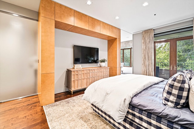 bedroom with access to outside, french doors, and dark wood-type flooring