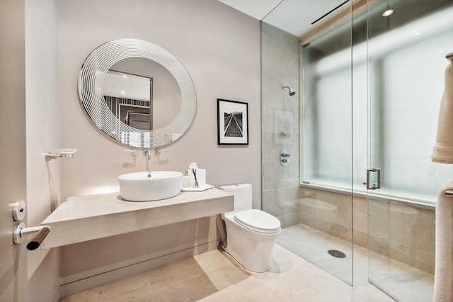 bathroom featuring sink, an enclosed shower, and toilet