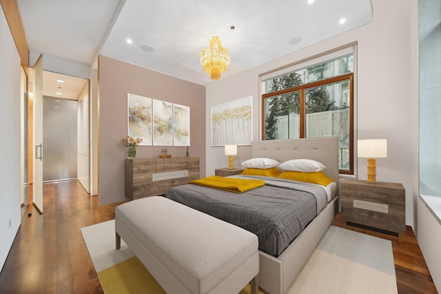 bedroom with a chandelier and wood-type flooring