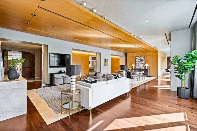 living room with hardwood / wood-style floors and wood walls