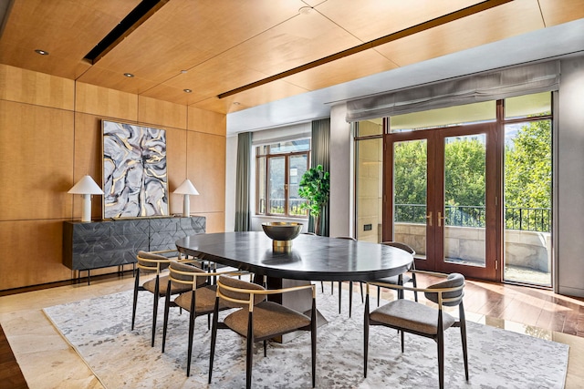 dining space with french doors, light hardwood / wood-style flooring, and wooden ceiling