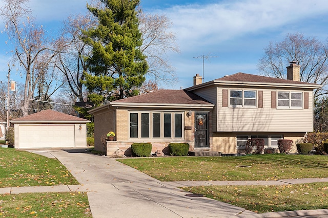 tri-level home featuring a garage, an outdoor structure, and a front yard