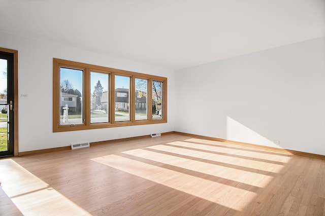 empty room with light hardwood / wood-style flooring