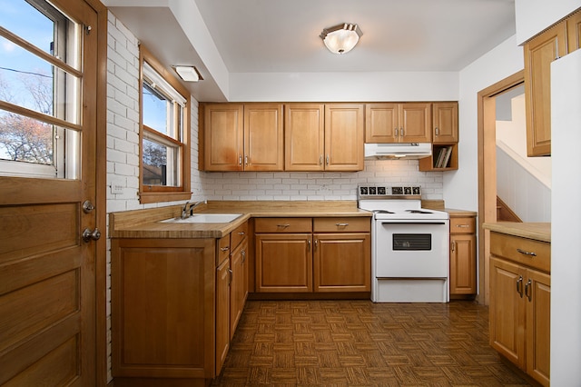 kitchen featuring electric range, decorative backsplash, dark parquet flooring, and sink