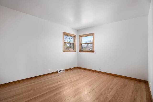 empty room with light hardwood / wood-style flooring