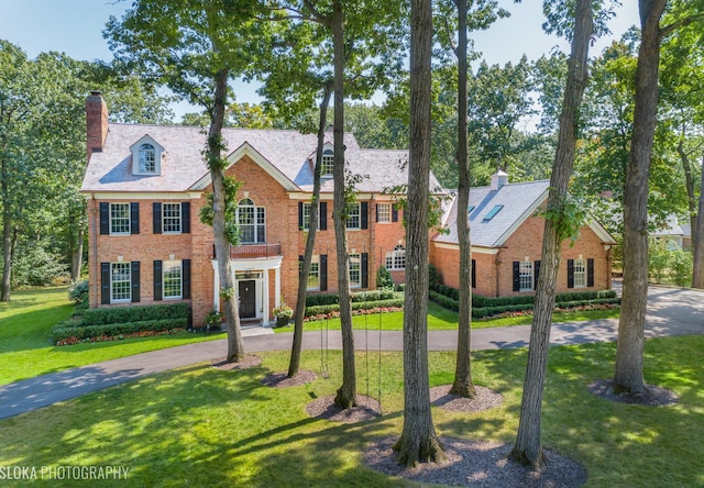 colonial home with a front yard