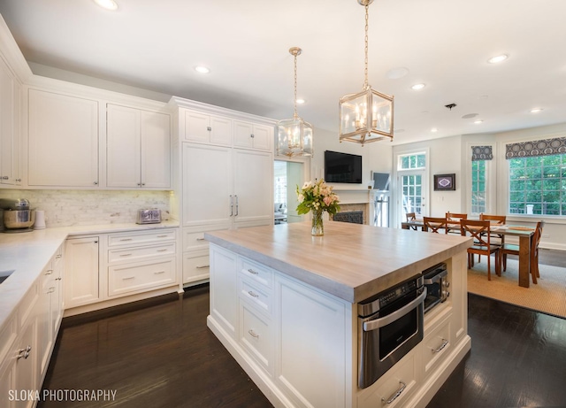 kitchen featuring white cabinetry, dark hardwood / wood-style flooring, and a center island