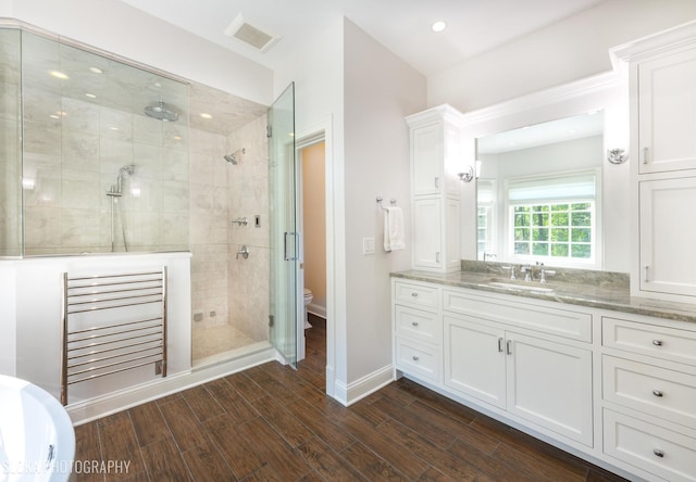 bathroom with vanity, an enclosed shower, and toilet